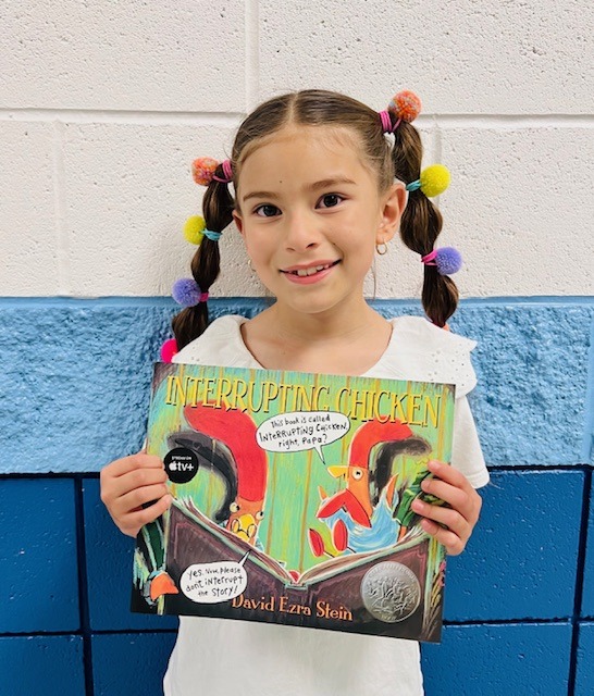 image_student receiving a book for earning a Aviator or Rise praise award