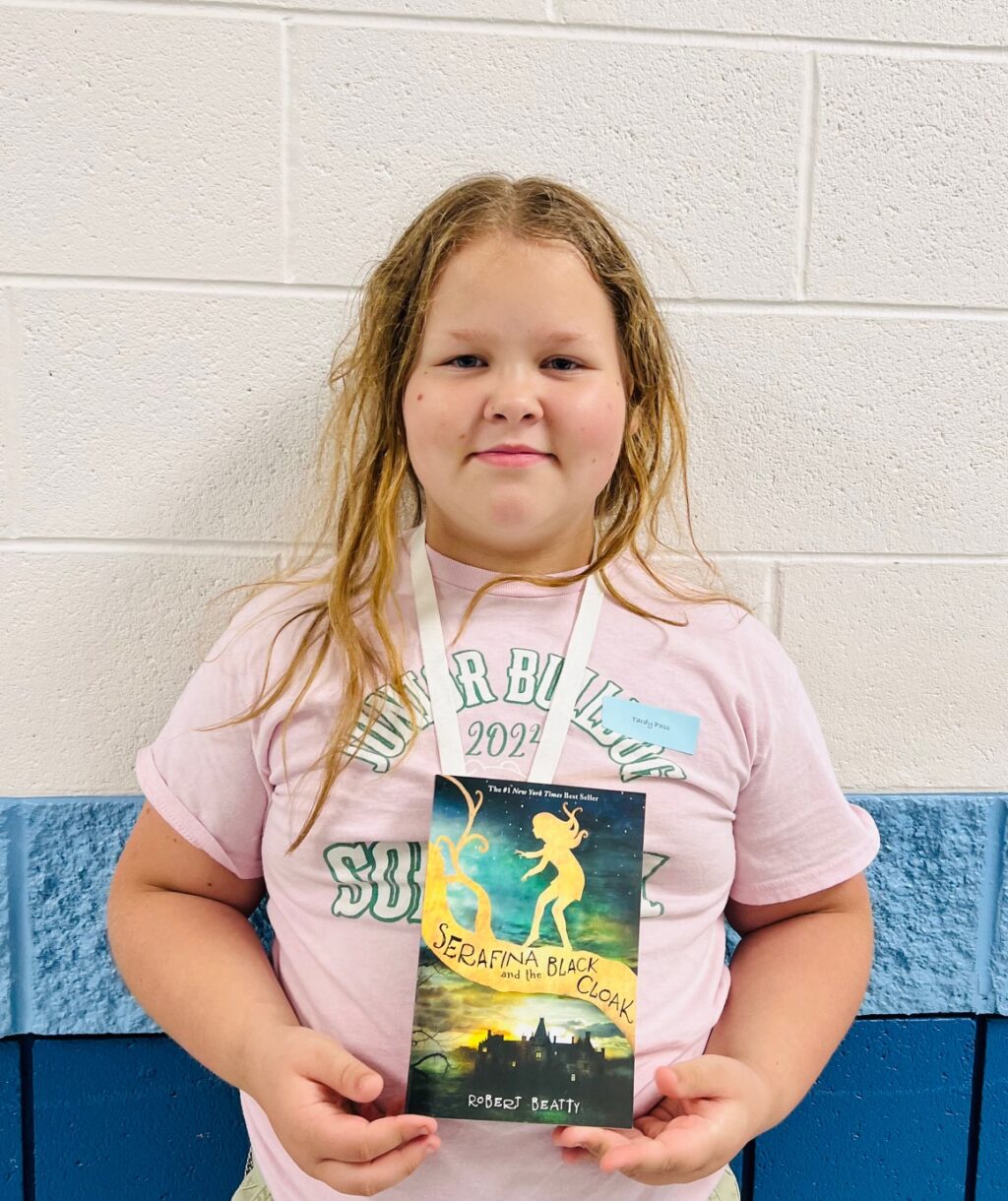 image_student receiving a book for earning a Aviator or Rise praise award