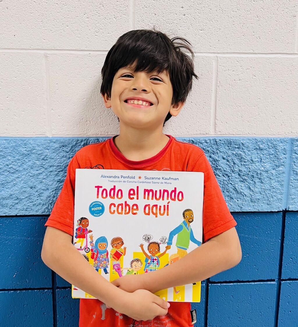 image_student receiving a book for earning a Aviator or Rise praise award