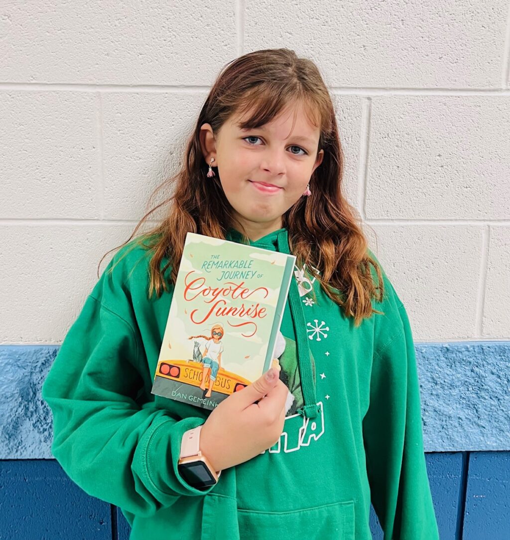 image_student receiving a book for earning a Aviator or Rise praise award