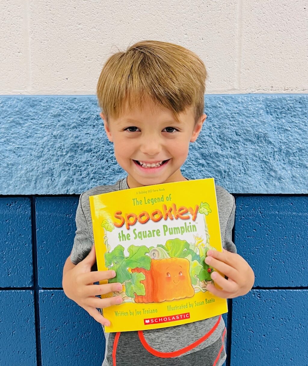 image_student receiving a book for earning a Aviator or Rise praise award