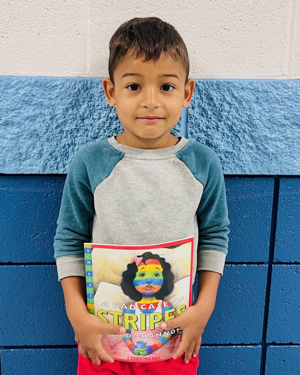 image_student receiving a book for earning a Aviator or Rise praise award