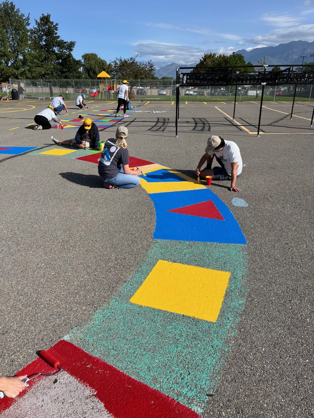 Image_United Way volunteers painting the playground blacktop