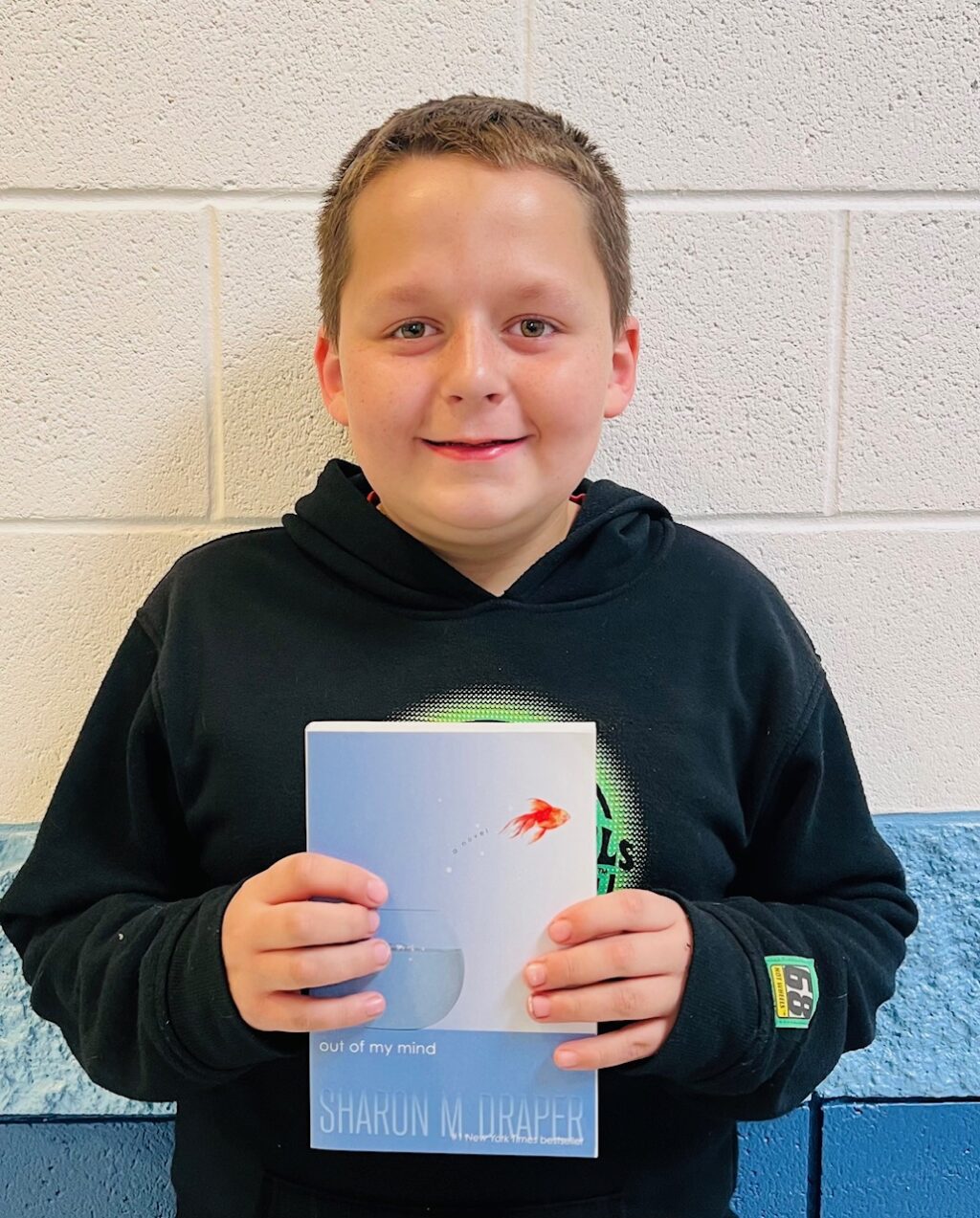 Image_student holding a book for earning an aviator or rise praise award