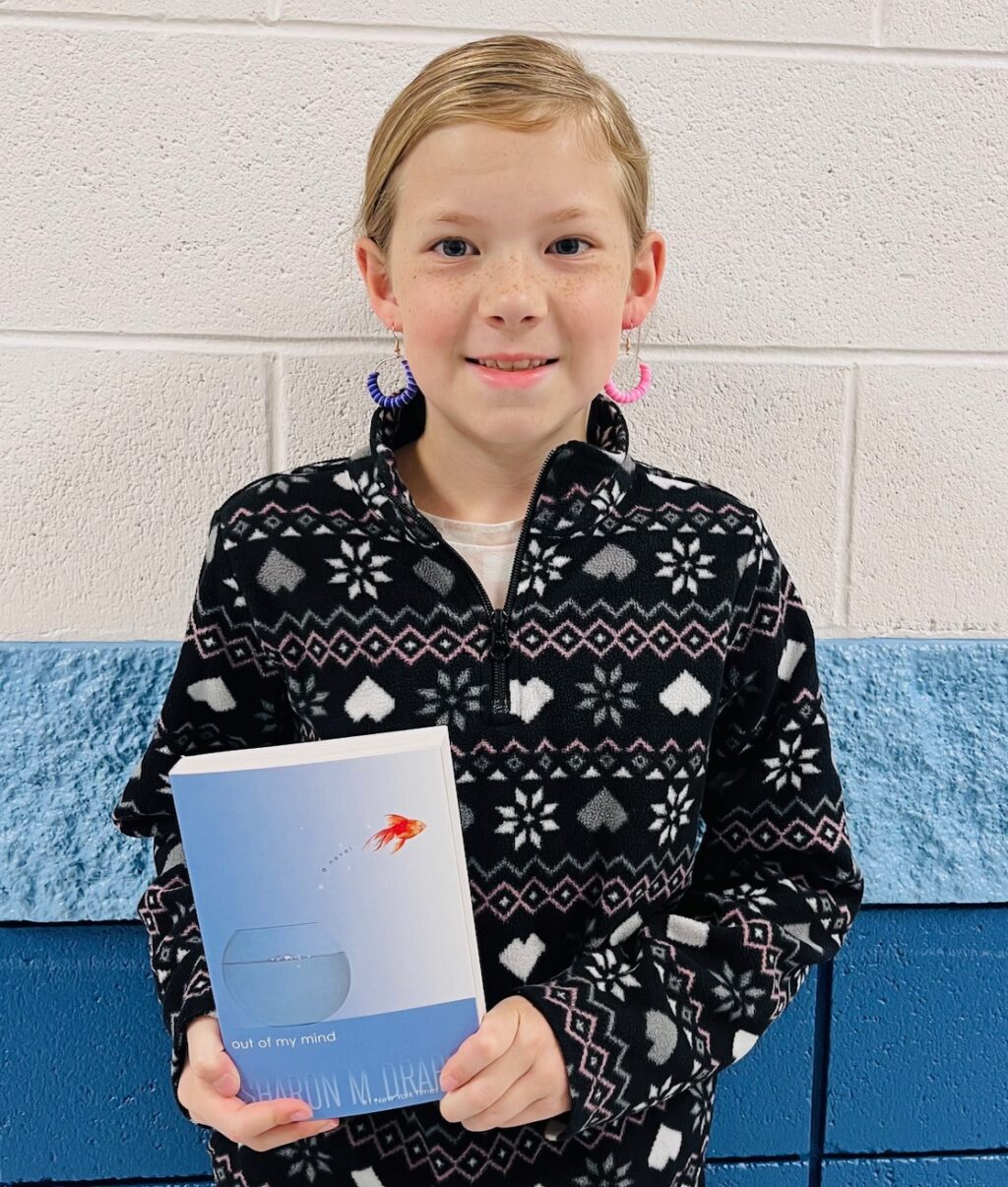 Image_student holding a book for earning an aviator or rise praise award