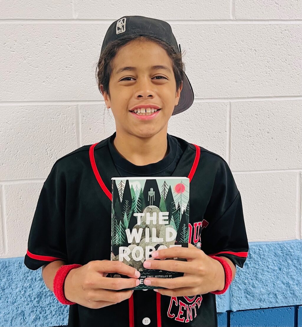 Image_student holding a book for earning an aviator or rise praise award