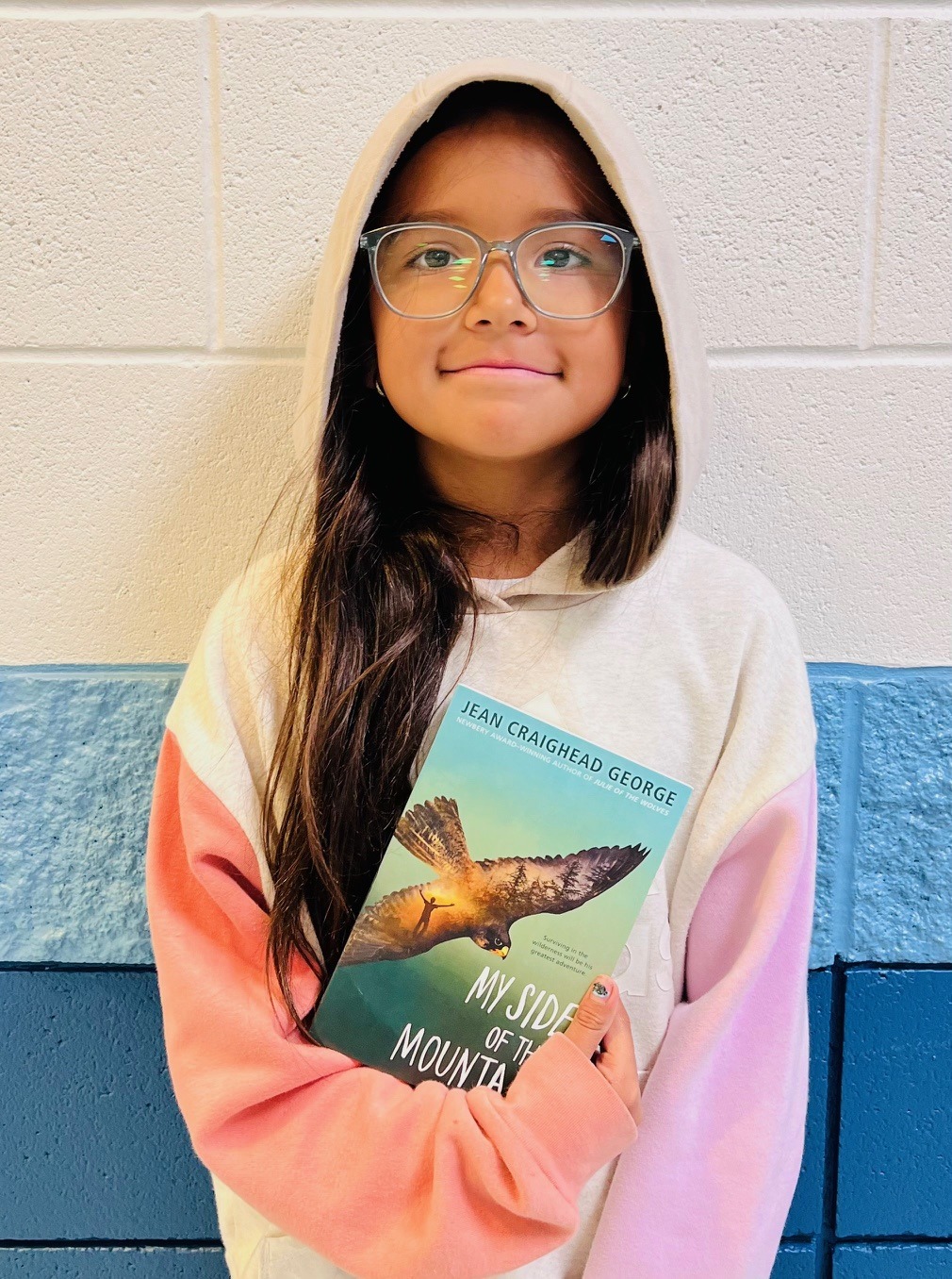 Image_student holding a book for earning an aviator or rise praise award