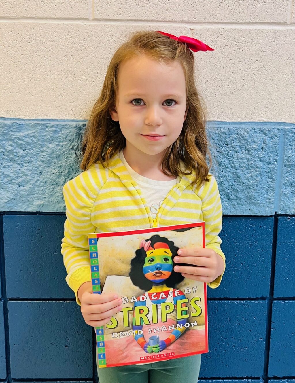 Image_student holding a book for earning an aviator or rise praise award