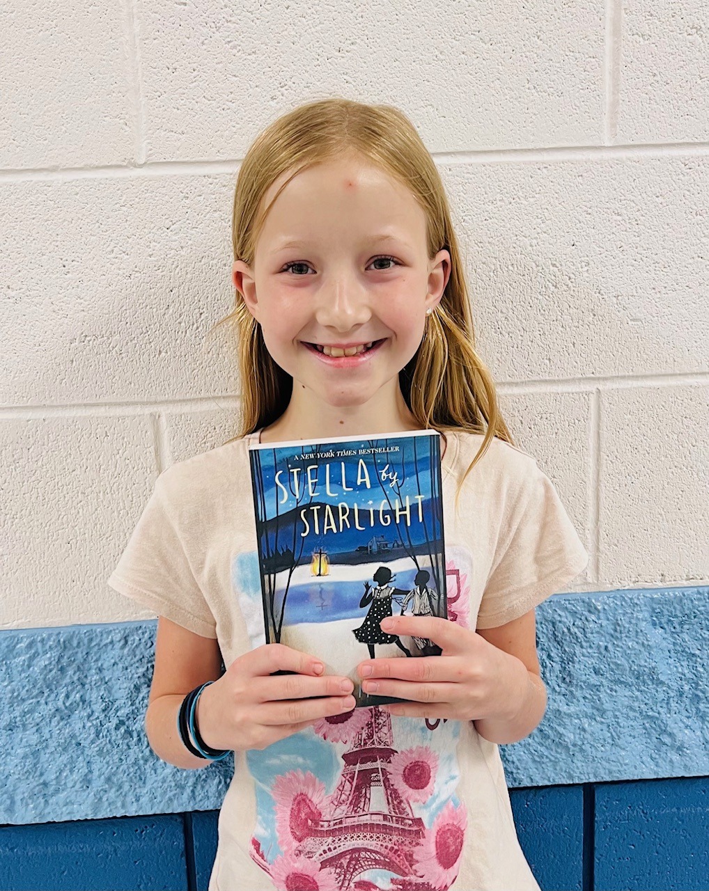 Image_student holding a book for earning an aviator or rise praise award