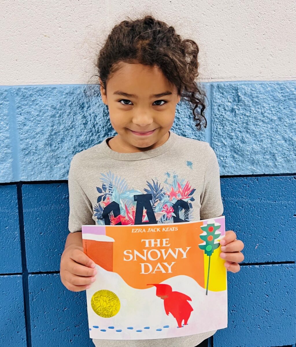 Image_student holding a book for earning an aviator or rise praise award