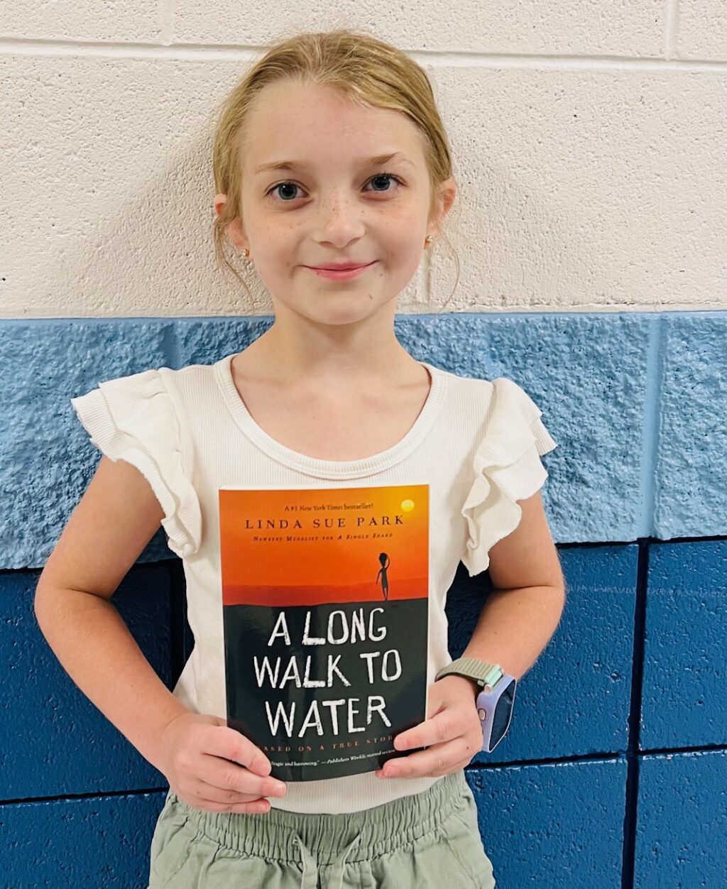 Image_student holding a book for earning an aviator or rise praise award