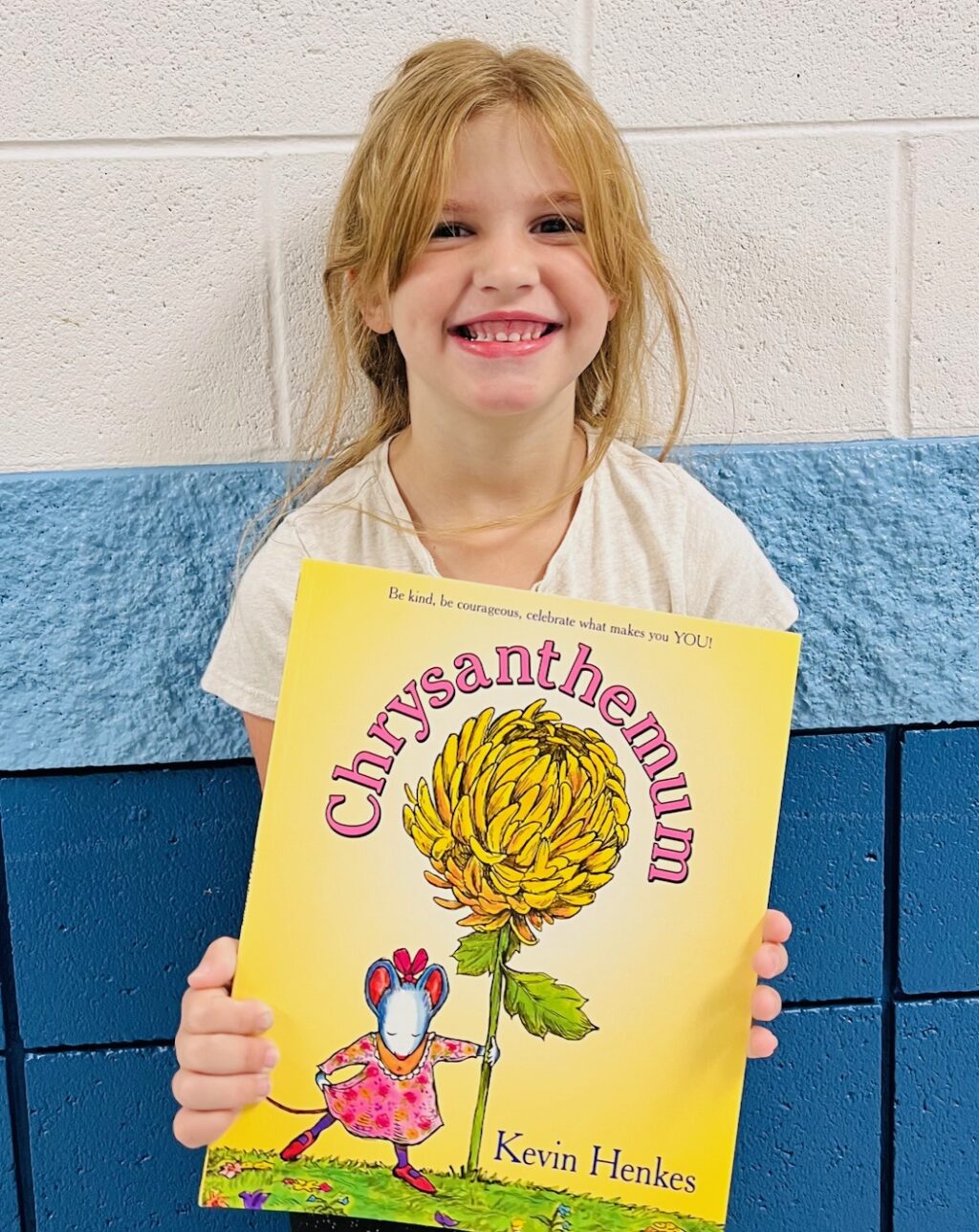 Image_student holding a book for earning an aviator or rise praise award