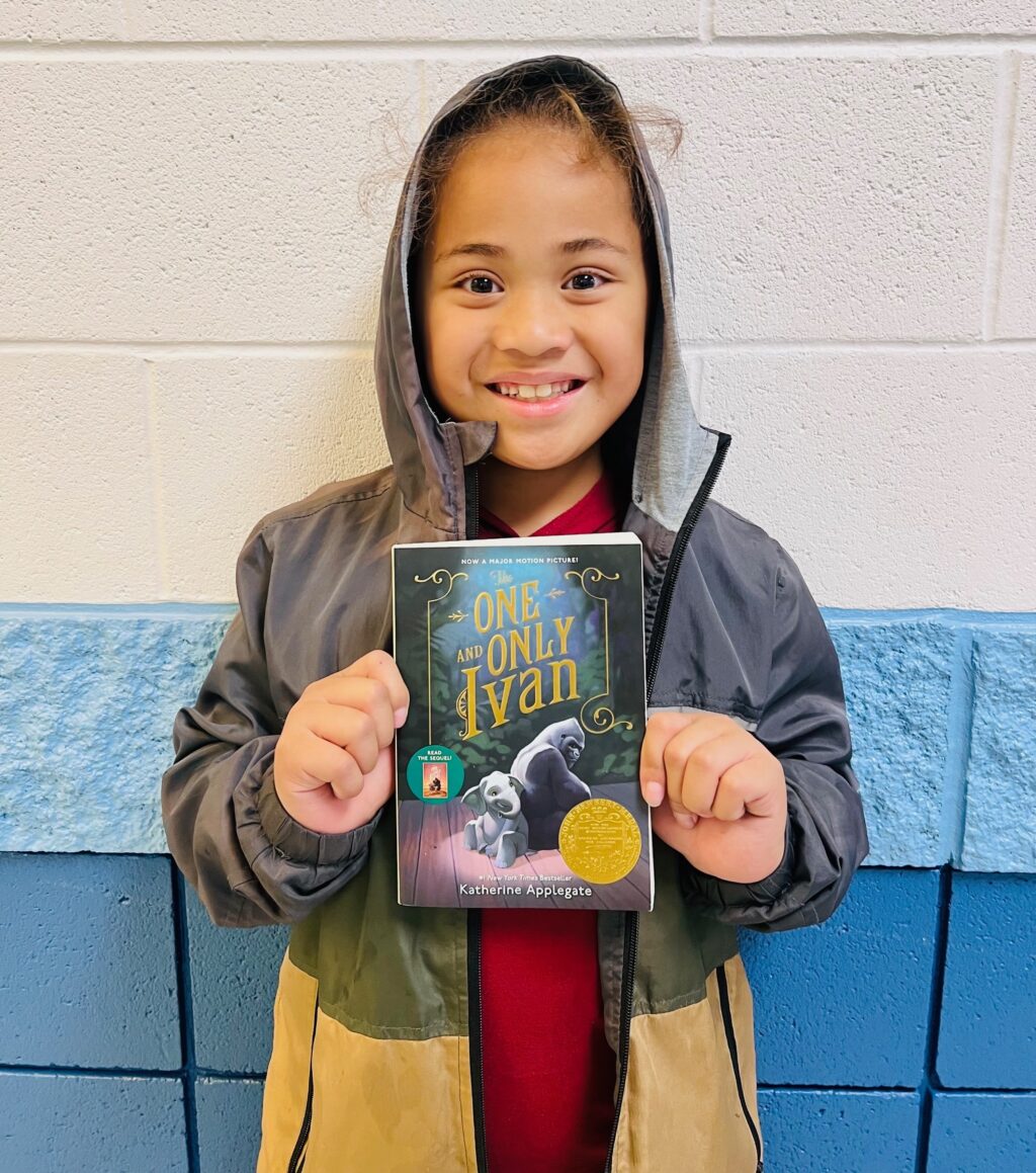 Image_student holding a book for earning an aviator or rise praise award