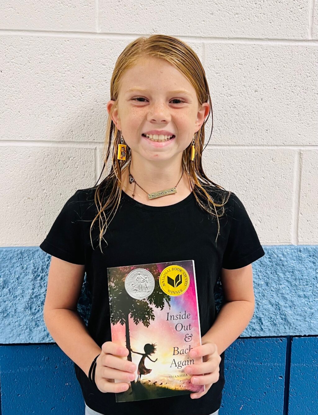 Image_student holding a book for earning an aviator or rise praise award