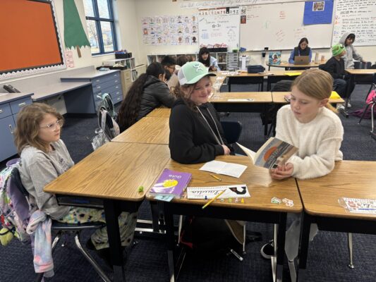 students involved in a reading challenge. Finding answers to answer questions about books they have read together.