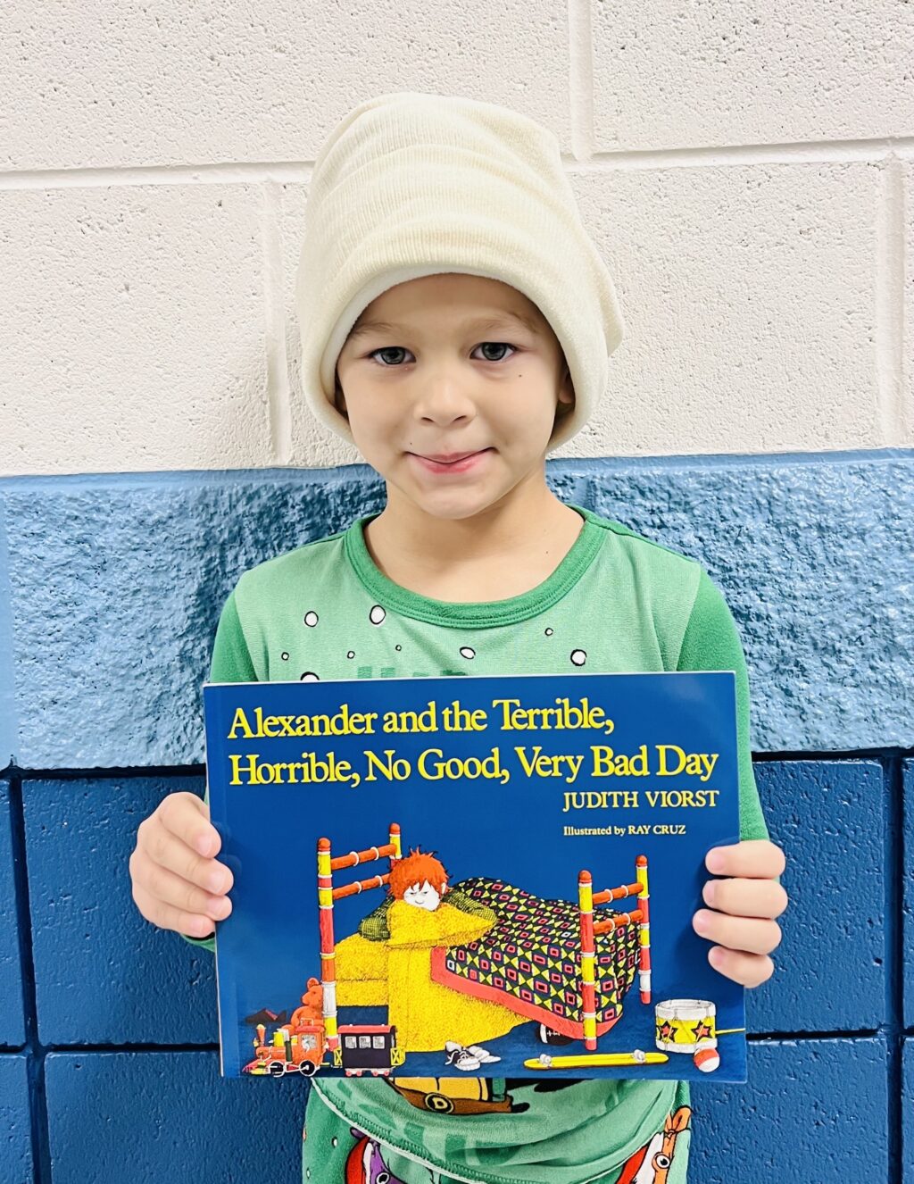 student holding a book they earned through a special recognition