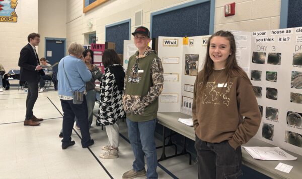 Amelia Earhart students are talking with STEM fair judges about their projects.