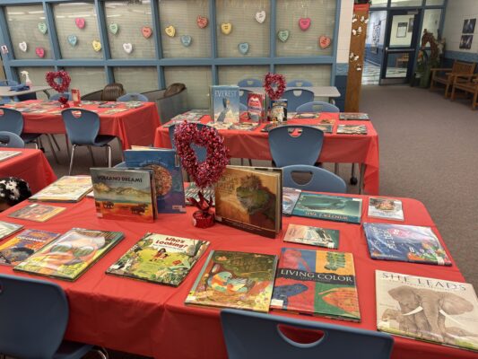 Extra special red table cloths hold the library books for speed dating