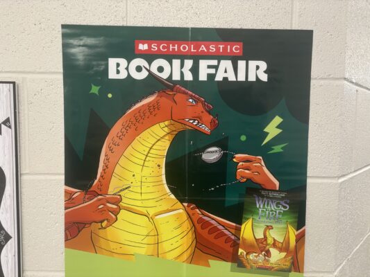 Scholastic Book Fair Poster of a dragon and the Wings of Fire Book Title