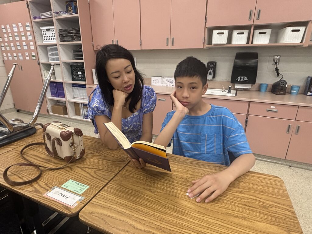 Students reading with  guests that could be parents, grandparents, family friends, or faculty and staff for read with a child day in May