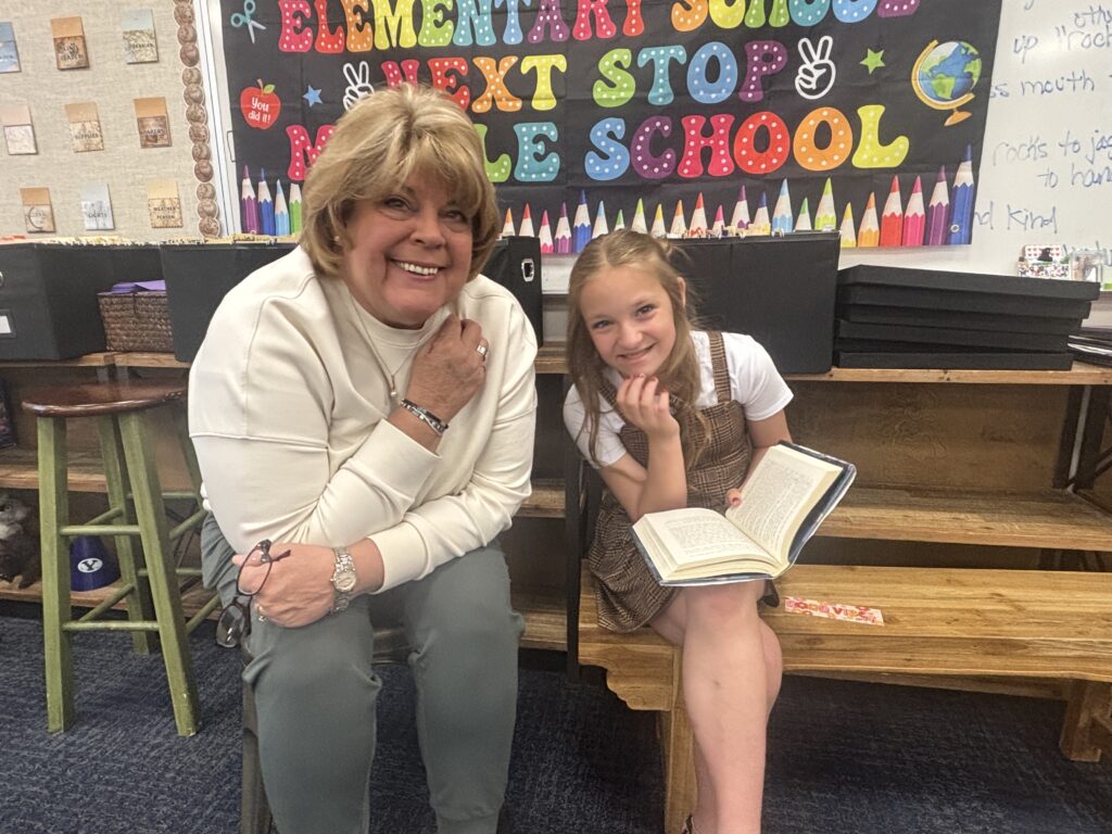 Students reading with  guests that could be parents, grandparents, family friends, or faculty and staff for read with a child day in May