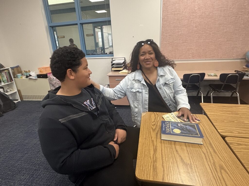Students reading with  guests that could be parents, grandparents, family friends, or faculty and staff for read with a child day in May