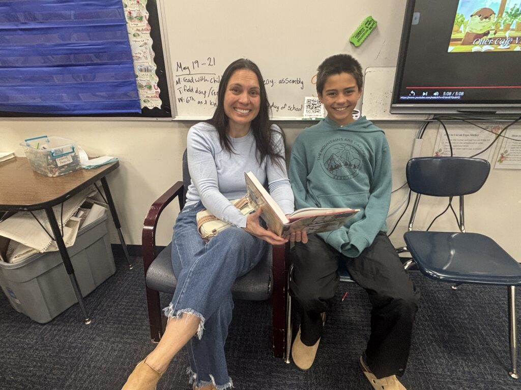 Students reading with  guests that could be parents, grandparents, family friends, or faculty and staff for read with a child day in May