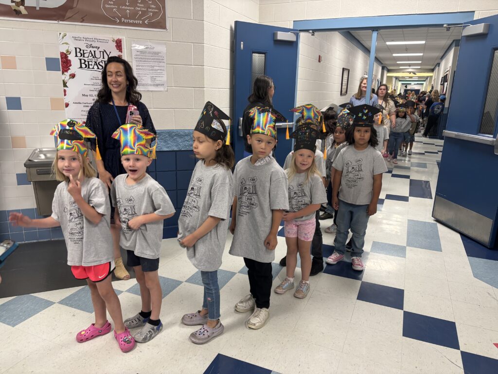 Kindergarten students walking the graduation loops around the school
