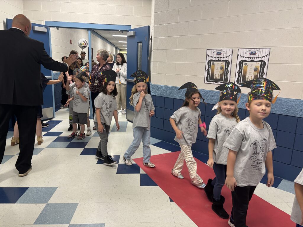 Kindergarten students walking the graduation loops around the school