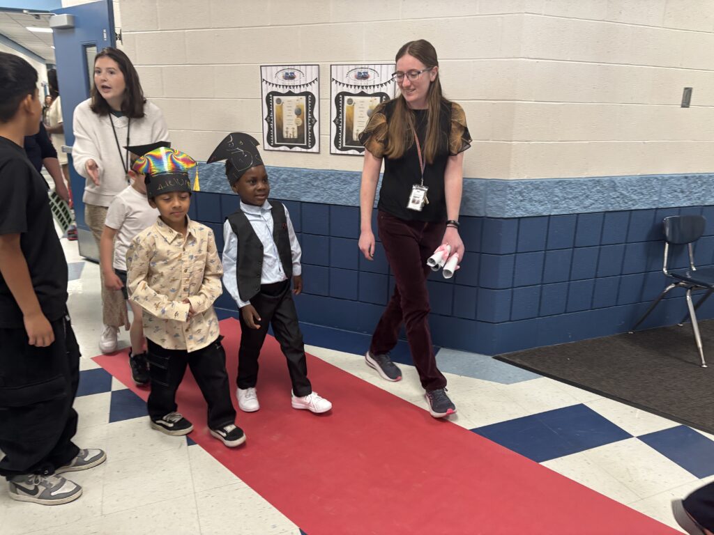 Kindergarten students walking the graduation loops around the school