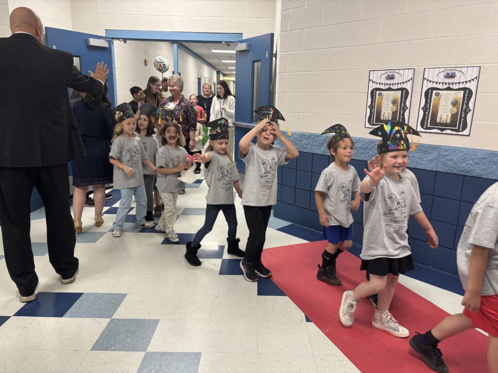 Kindergarten students walking the graduation loops around the school