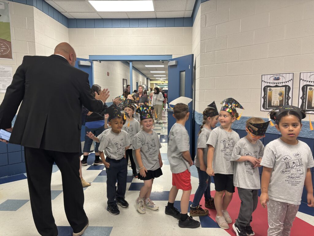 Kindergarten students walking the graduation loops around the school