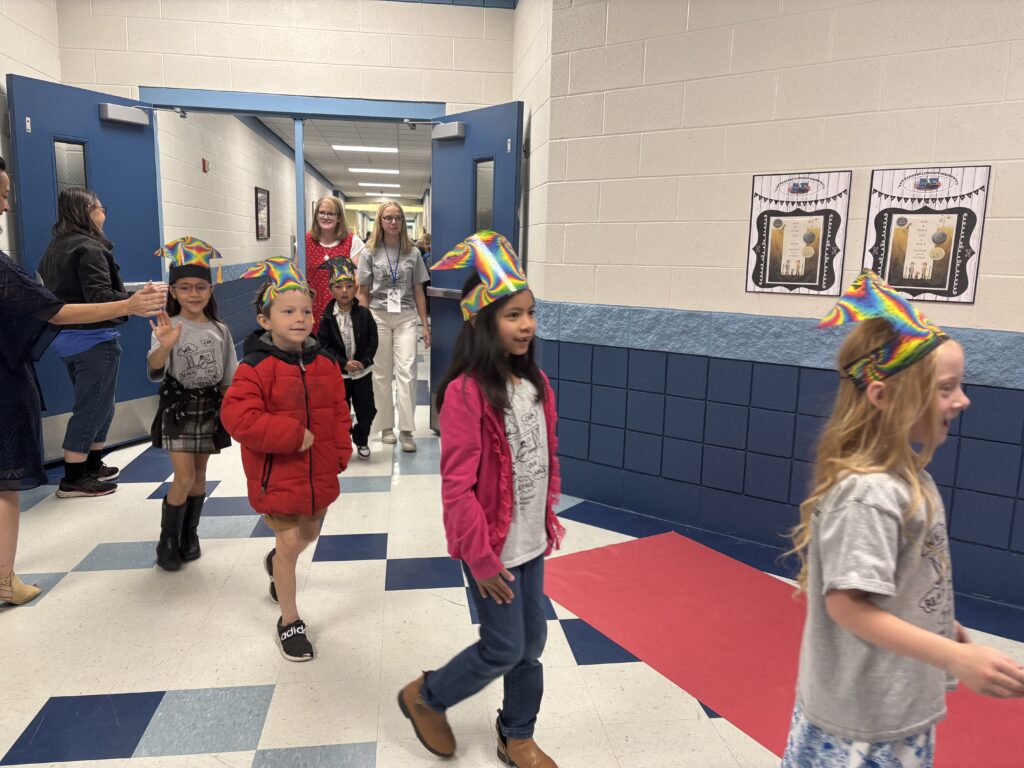Kindergarten students walking the graduation loops around the school