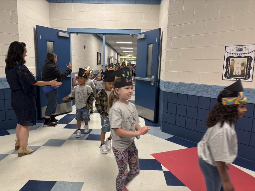 Kindergarten students walking the graduation loops around the school