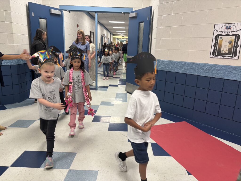 Kindergarten students walking the graduation loops around the school