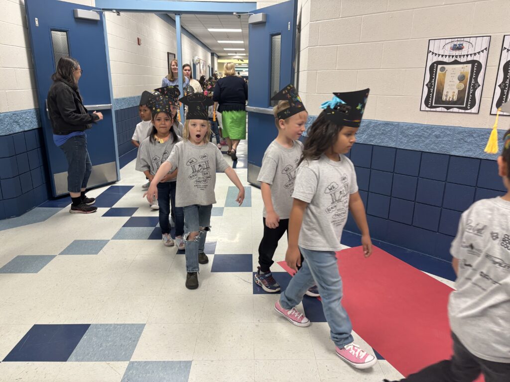 Kindergarten students walking the graduation loops around the school