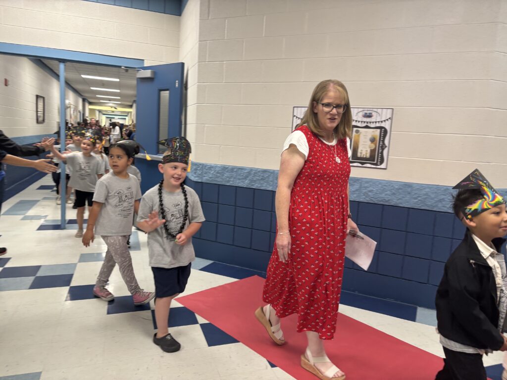 Kindergarten students walking the graduation loops around the school