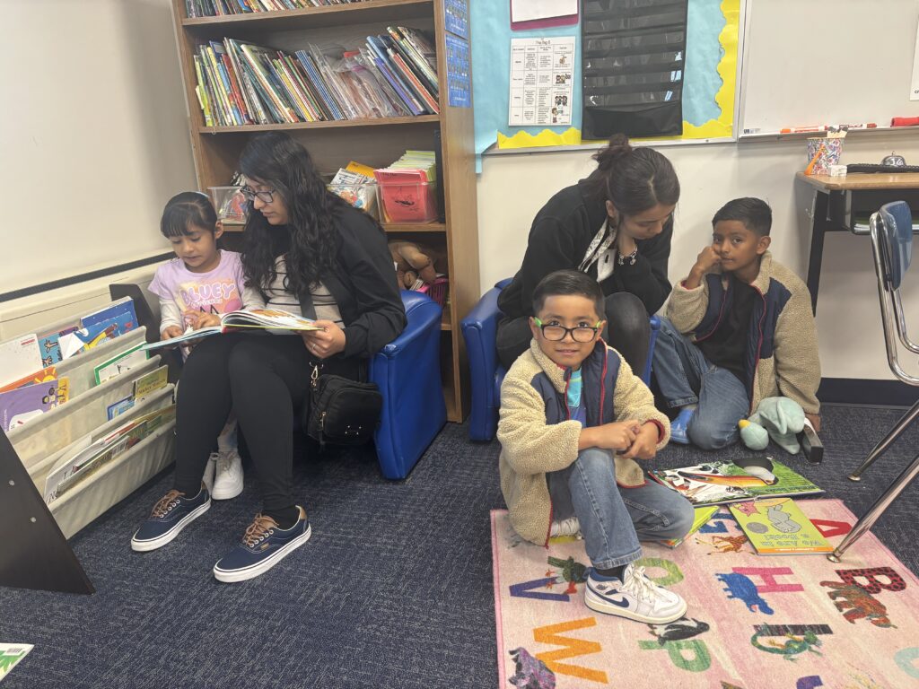 Students reading with  guests that could be parents, grandparents, family friends, or faculty and staff for read with a child day in May