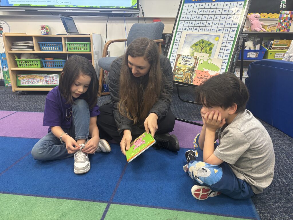 Students reading with  guests that could be parents, grandparents, family friends, or faculty and staff for read with a child day in May