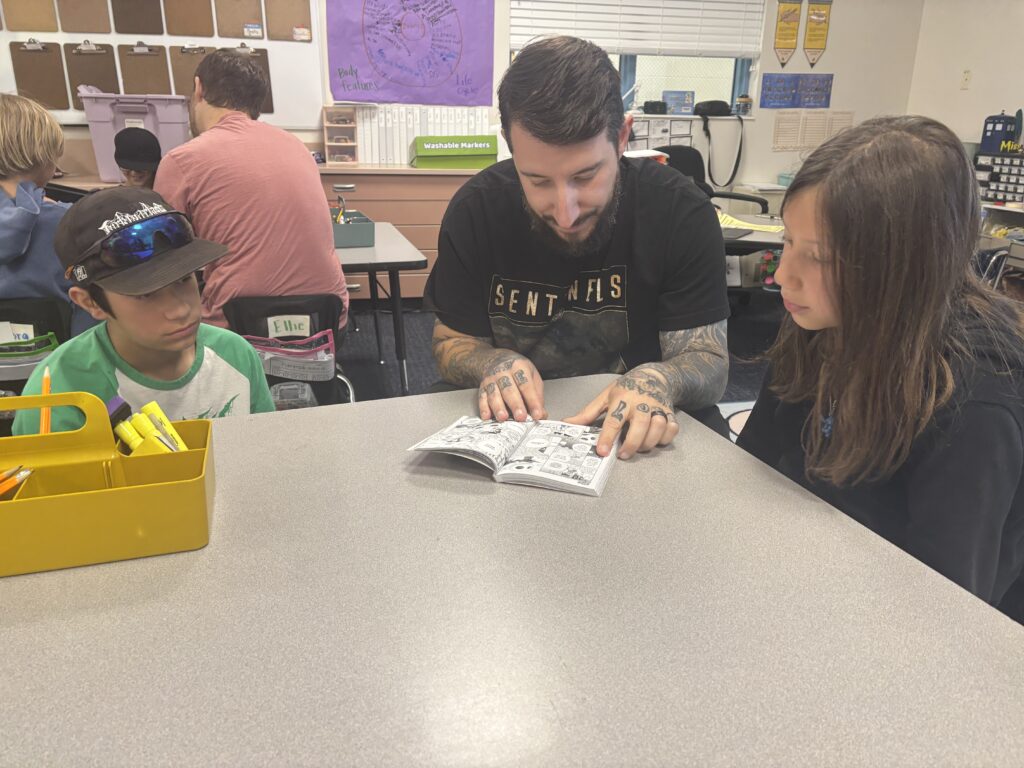 Students reading with  guests that could be parents, grandparents, family friends, or faculty and staff for read with a child day in May