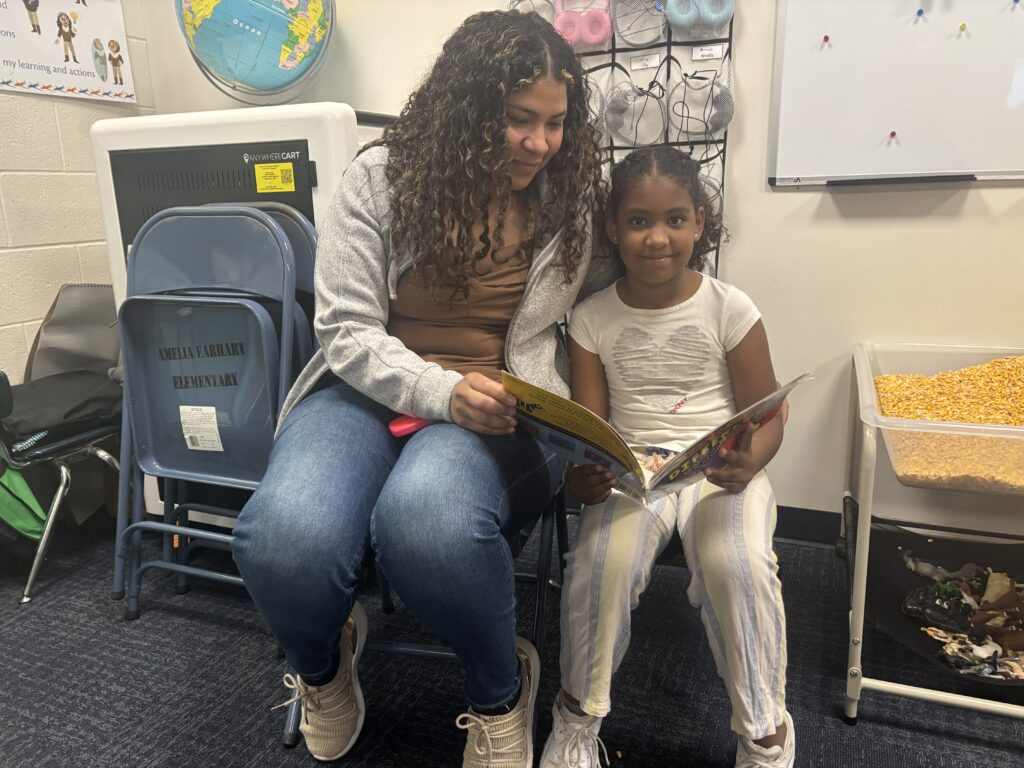 Students reading with  guests that could be parents, grandparents, family friends, or faculty and staff for read with a child day in May