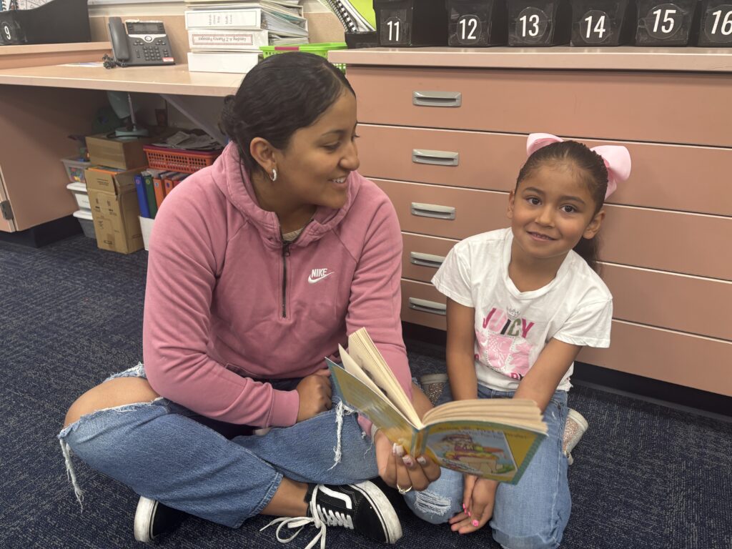 Students reading with  guests that could be parents, grandparents, family friends, or faculty and staff for read with a child day in May