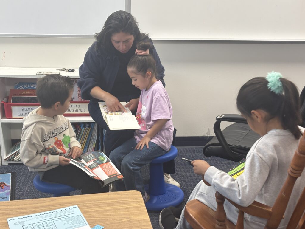 Students reading with  guests that could be parents, grandparents, family friends, or faculty and staff for read with a child day in May
